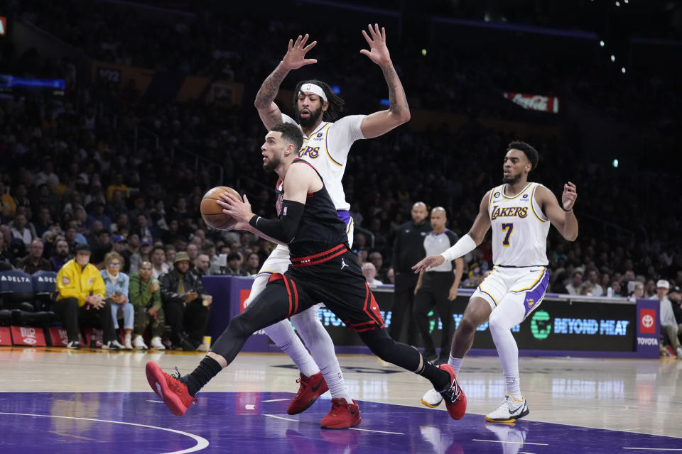 Chicago Bulls guard Zach LaVine drives past Los Angeles Lakers forward Anthony Davis, top center, during the first half of an NBA basketball game Sunday, March 26, 2023, in Los Angeles. (AP Photo/Marcio Jose Sanchez)
