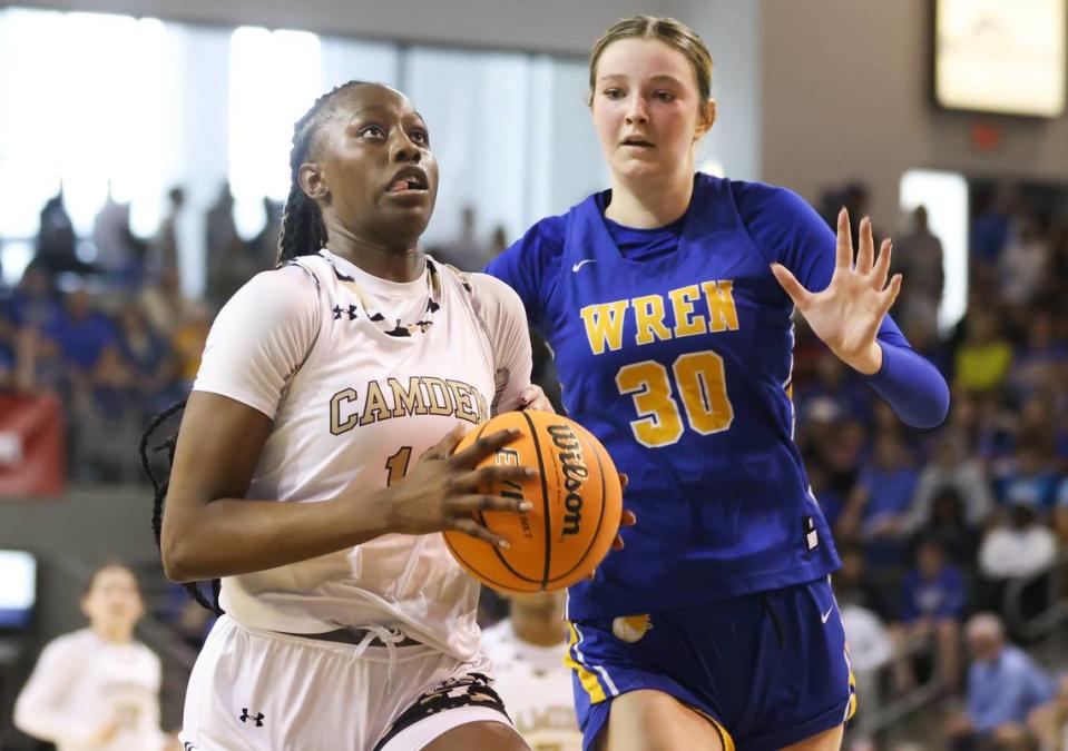 Joyce Edwards (12) of Camden goes for a layup as Riley Stack (30) of Wren tries to defend during Camden’s game against Wren in the SCHSL Class 3A State Championship at the USC Aiken Convocation Center on Friday, March 3, 2023.