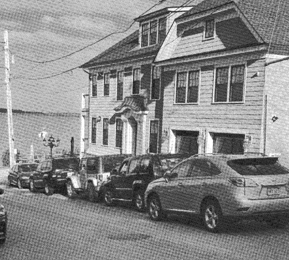 Cars are parked along Orchard Street outside 153 Bayside Road in Quincy. The city filed a contempt complaint against the property owner, Ronen Zangi, saying he violated a court order forbidding short-term rentals of the property.