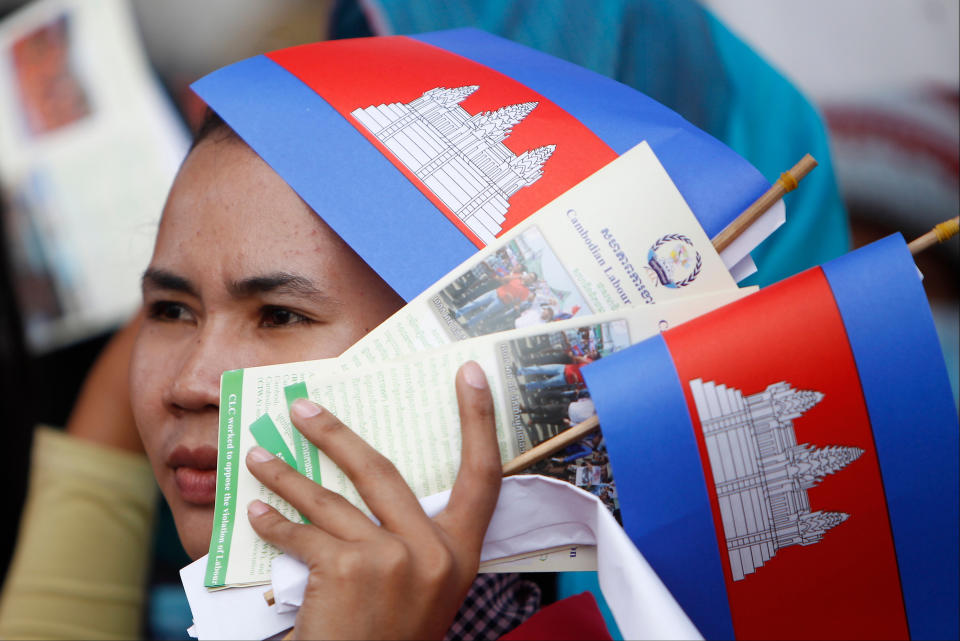 FILE - In this May 1, 2018, file photo, a worker participates during a gathering to mark May Day at Tonle Sap river bank, in Phnom Penh, Cambodia. Cambodia's government announced Friday it is raising the minimum wage for the garment industry, the country's biggest export earner, whose workers make up a powerful political bloc. (AP Photo/Heng Sinith, File)