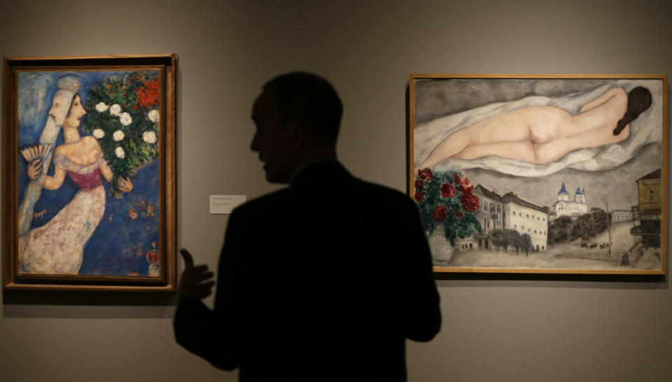 In this photo taken Wednesday, Feb. 13, 2013, museum curator Olivier Meslay talks about paintings by artist Marc Chagall included in the "Chagall: Beyond Color," exhibit during a preview at the Dallas Museum of Art in Dallas. This will be the only U.S. venue to host the exhibit that opens to the public on Sunday. (AP Photo/LM Otero)