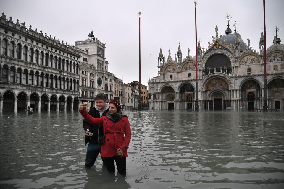 People take selfie photos in St Mark's square (Getty)