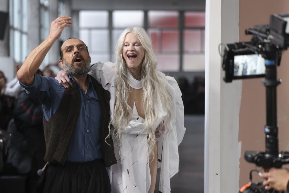 Designer Andreas Kronthaler, left, and Kristen McMenamy accept applause after the Vivienne Westwood Fall/Winter 2024-2025 ready-to-wear collection presented Saturday, March 2, 2024 in Paris. (Photo by Vianney Le Caer/Invision/AP)