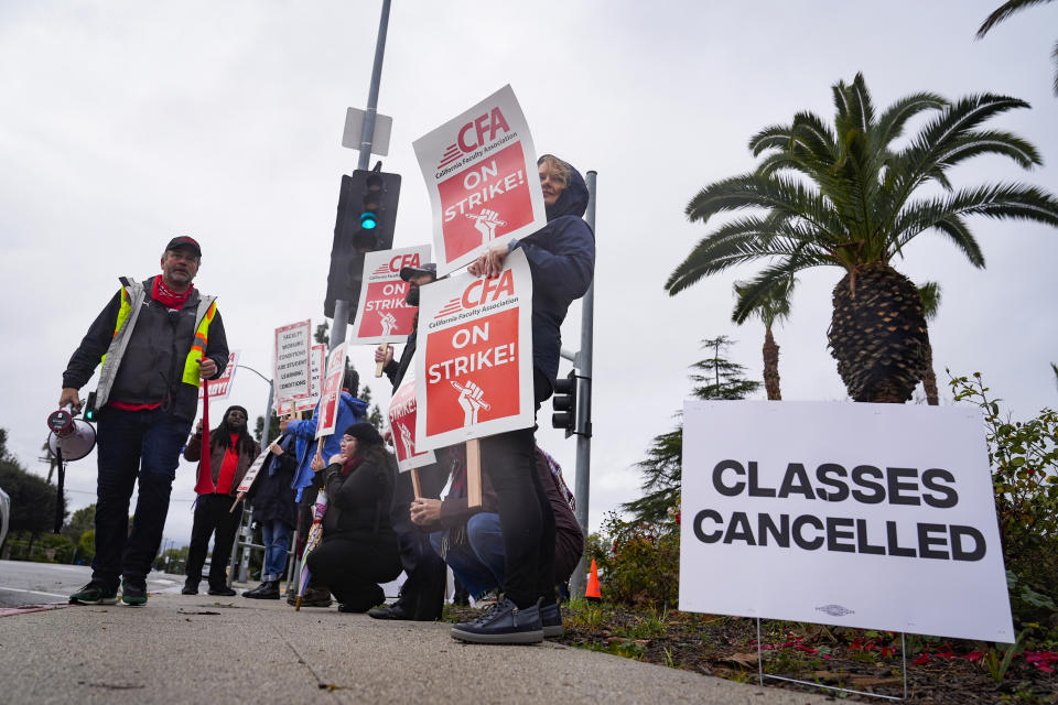 Demonstrators picket outside the Cal State Northridge campus Monday, Jan. 22, 2024, in Northridge, Calif. More than 30,000 professors, librarians, plumbers, electricians, and other workers at California State University, the largest public university system in the U.S., have started a weeklong strike on Monday to demand higher wages. (AP Photo/Marcio Jose Sanchez)