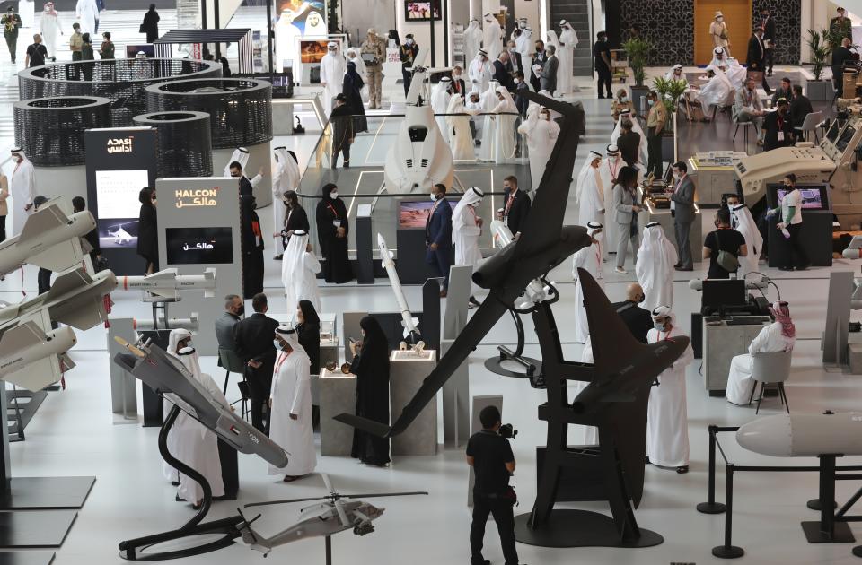 People visit military equipment on display during the opening day of the International Defence Exhibition & Conference, IDEX, in Abu Dhabi, United Arab Emirates, Sunday, Feb. 21, 2021. (AP Photo/Kamran Jebreili)