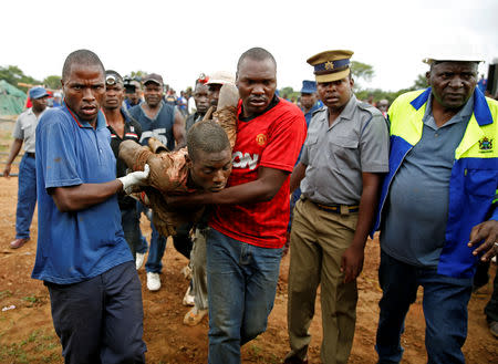 A rescued artisinal miner is carried from a pit as retrieval efforts proceed for trapped illegal gold miners in Kadoma, Zimbabwe, February 16, 2019. REUTERS/Philimon Bulawayo