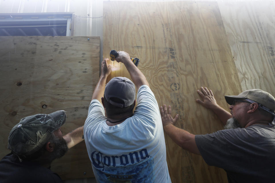 LAKE  CHARLES, LOUISIANA - OCTOBER 08: Local volunteers help board up a business ahead of Hurricane Delta on October 8, 2020 in Lake Charles, Louisiana. Residents along the Gulf Coast are bracing for the arrival of Hurricane Delta which is expected to make landfall in Louisiana on October 9. (Photo by Mario Tama/Getty Images)