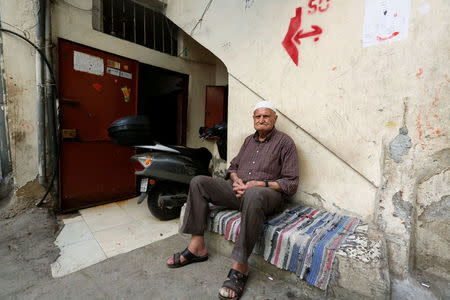 Palestinian refugee Abu Ahmad sits at Shatila refugee camp, in Beirut, Lebanon, April 19, 2018. REUTERS/Jamal Saidi