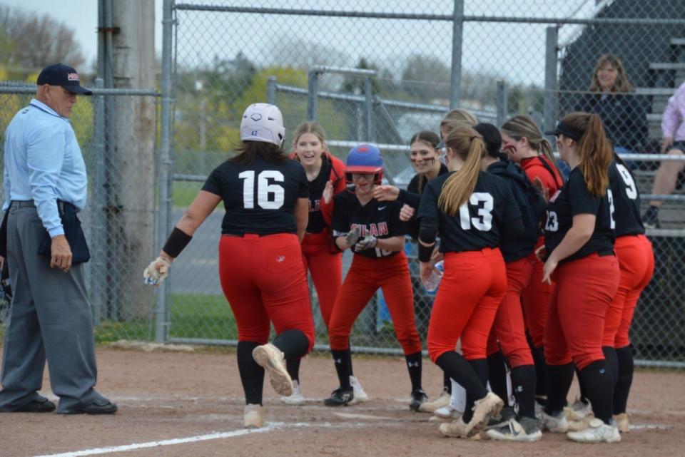 Mariah Stines is greeted by her Milan teammates after hitting a home run Wednesday during a 4-1 win over Airport.