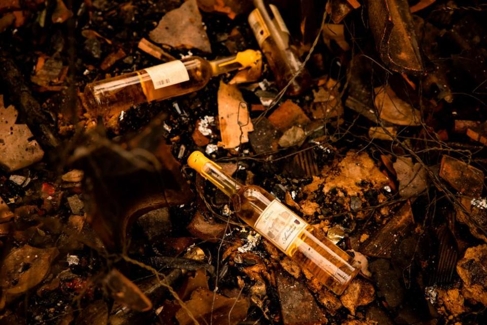 Charred bottles of wine from the Castello di Amorosa winery sit in the debris of the Glass fire, which gutted part of the property.