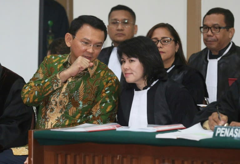 Basuki Tjahaja Purnama (left) consults his lawyer at his blasphemy trial in Jakarta on February 28, 2017