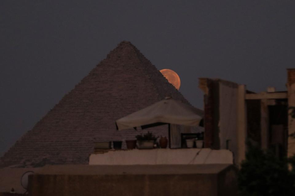 A view of the super blue moon behind the Pyramids of Giza in Egypt on Aug. 31, 2023.<span class="copyright">Mohamed Elshahed—Anadolu Agency/Getty Images</span>