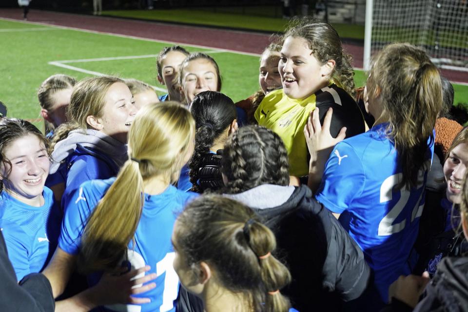 Cumberland goalie Payton Goulding is celebrated by teammates after the final horn sounded on their 2-0 win over North Kingstown, sending the Clippers to Saturday's State Championship game at Rhode Island College.