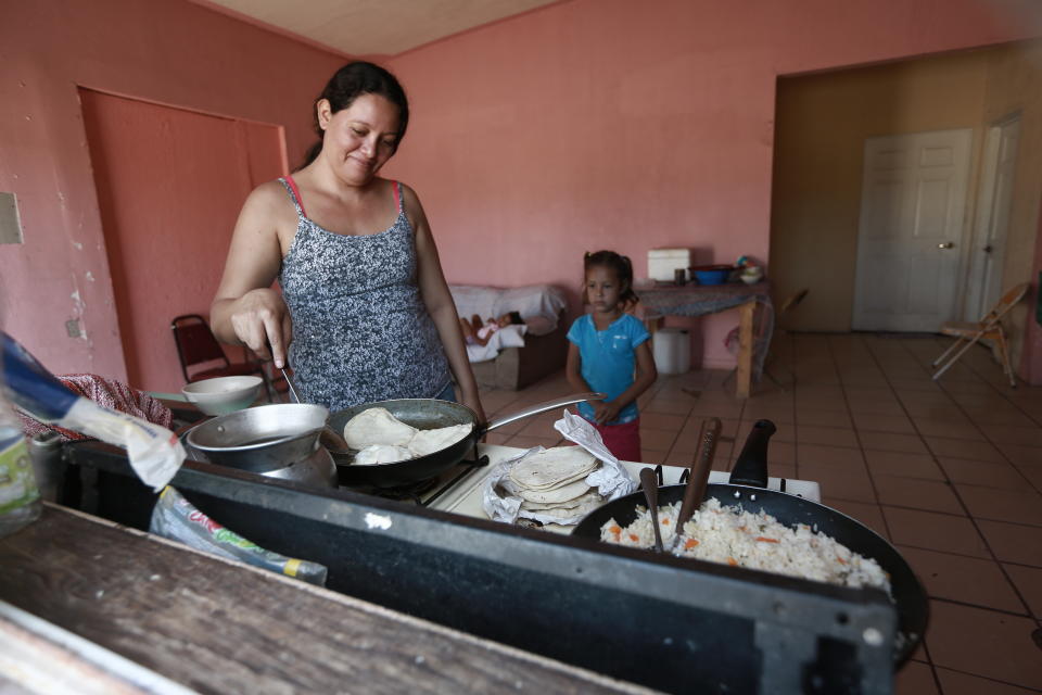 A Honduran migrant prepares tortillas and rice at the Pan de Vida shelter for migrants where she and her two daughters are living while waiting their turn to apply for asylum in the U.S. in Ciudad Juarez, Mexico, Thursday, Sept. 12, 2019. Mexican Foreign Secretary Marcelo Ebrard said Thursday that Mexico's government doesn't agree with an "astonishing" U.S. Supreme Court order that would block migrants from countries other than Mexico and Canada from applying for asylum at U.S. borders. (AP Photo/Christian Chavez)