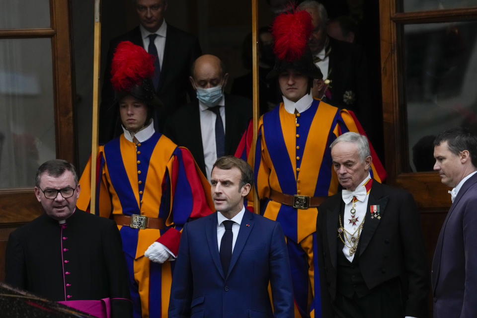 French President Emmanuel Macron, center leaves the Vatican after a meeting with Pope Francis, Friday, Nov. 26, 2021. (AP Photo/Andrew Medichini)