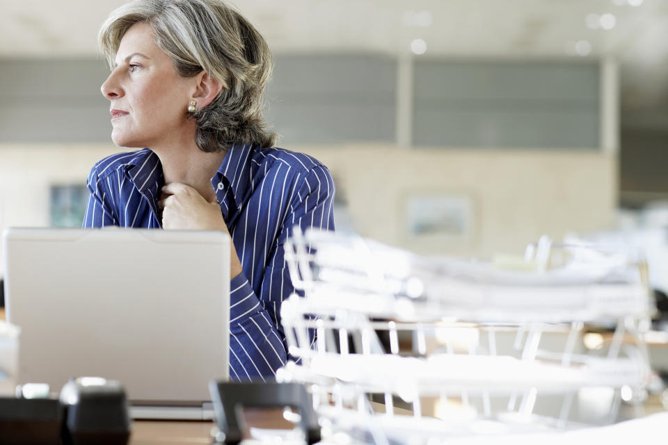 Older woman at laptop, deep in thought