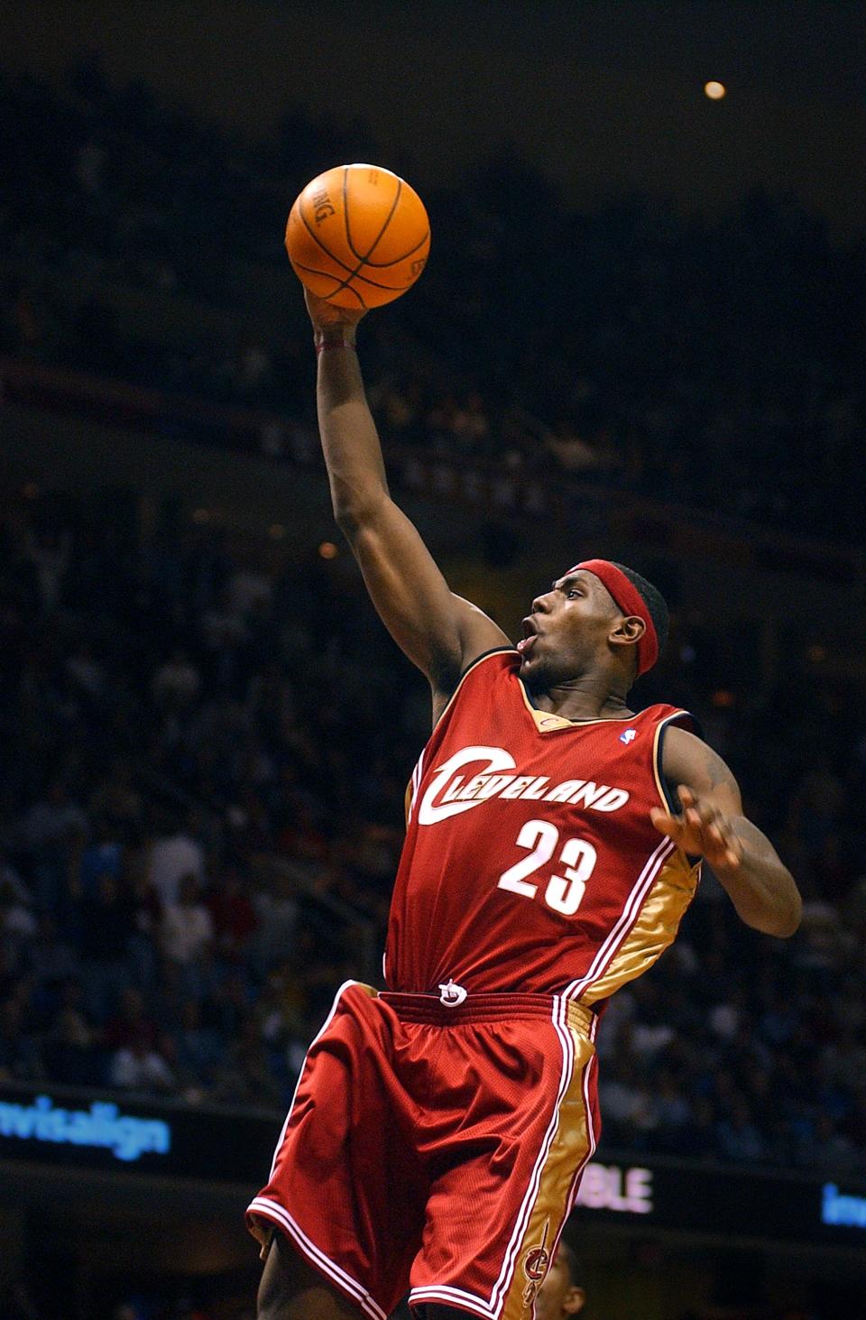 As a Cavaliers rookie, LeBron James glides through the air on his way to a dunk during a game against the New Jersey Nets at the Gund Arena on March 27, 2004, in Cleveland.