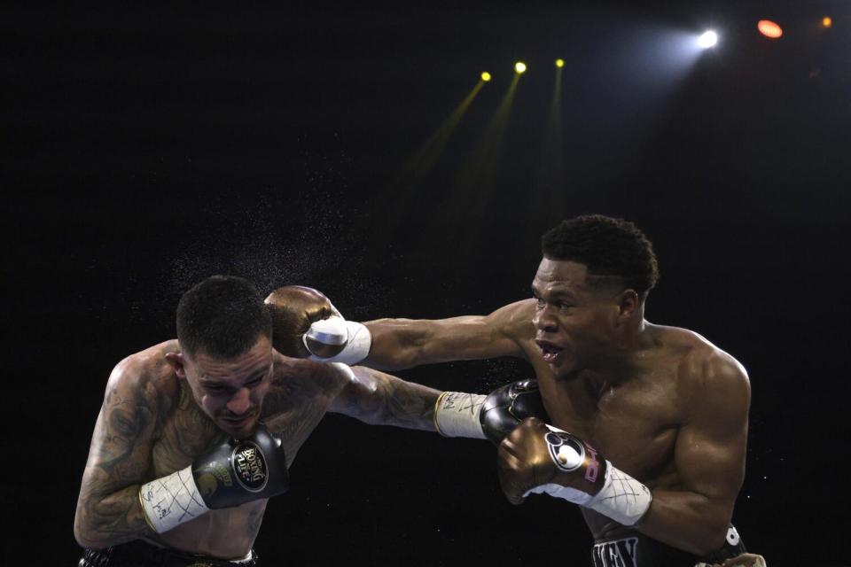 Devin Haney lands a blow to the head of George Kambosos Jr. during an undisputed lightweight boxing match
