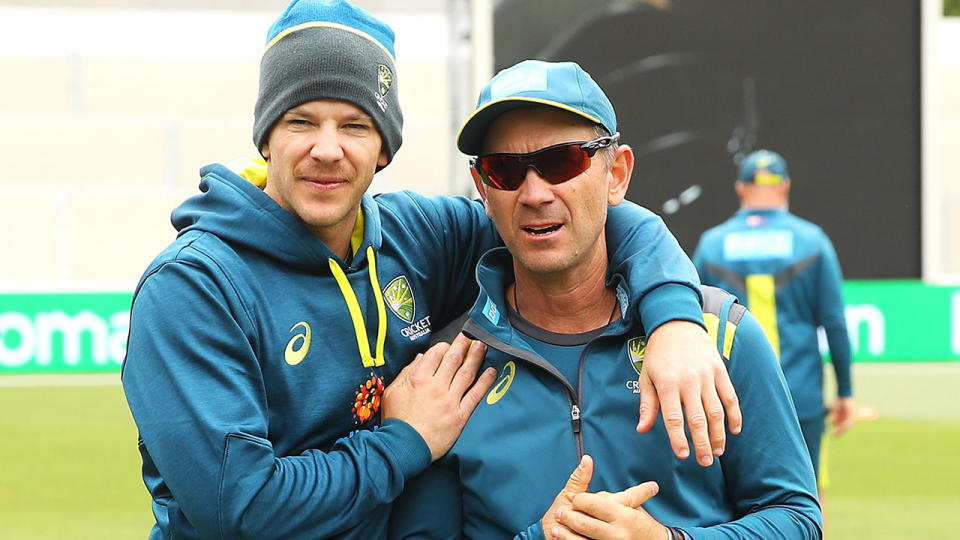 Australian cricket captain Tim Paine and coach Justin Langer are seen here embracing at a practice session.