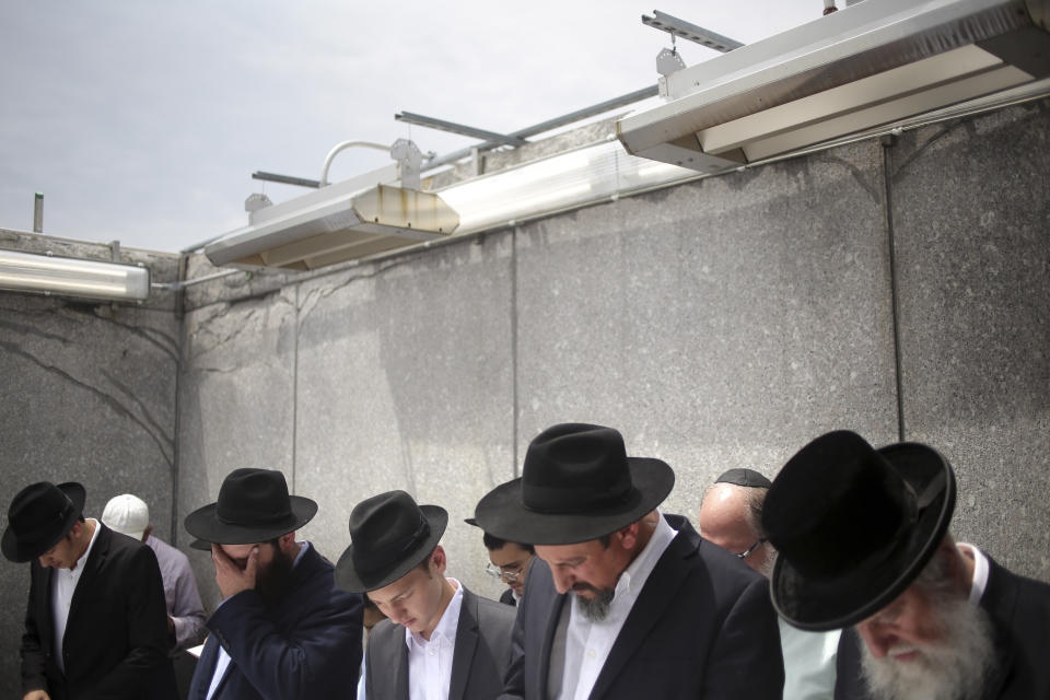 In this July 2, 2019 photo, people pray at the gravesite of Rabbi Menachem M. Schneerson in the Queens borough of New York, Tuesday, July 2, 2019. Yuli Edelstein, the speaker of Israel’s parliament who spent three years in Soviet prison in the 1980s before immigrating to Israel, said he “was a model of love for Israel and instilled in the Jewish nation a belief in its eternal values that protected us for thousands of years and will protect us forever.” (AP Photo/Seth Wenig)
