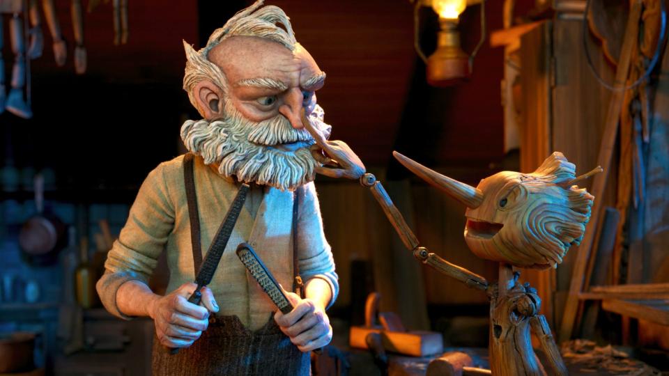 (L-R) Gepetto (voiced by David Bradley) and Pinocchio in Guillermo del Toro's Pinocchio