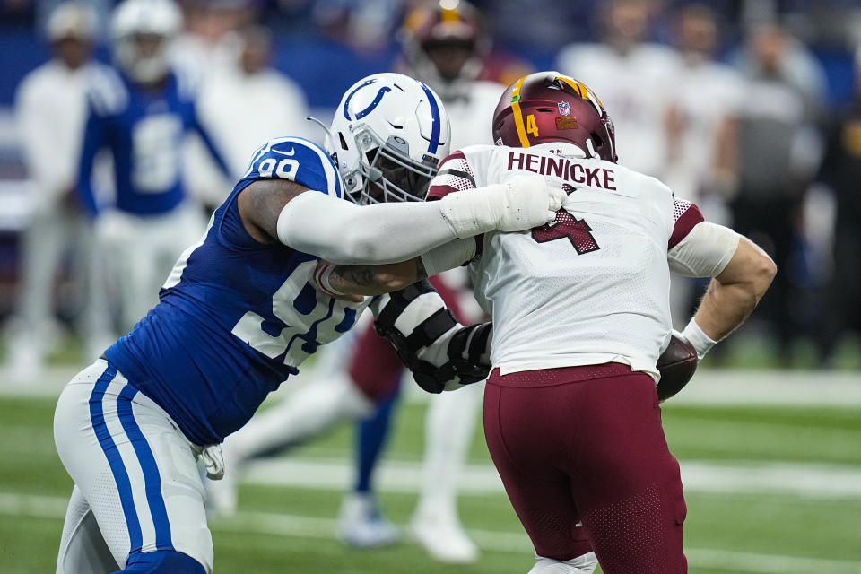 Indianapolis Colts defensive tackle DeForest Buckner (99) sacks Washington Commanders quarterback Taylor Heinicke (4) in the first half of an NFL football game in Indianapolis, Sunday, Oct. 30, 2022. (AP Photo/Darron Cummings)