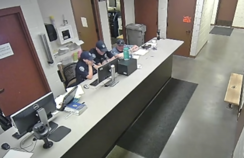 Austin Hopp and Daria Jalali and another police officer with Loveland Police Department watch bodycam of Karen Garner's arrest.