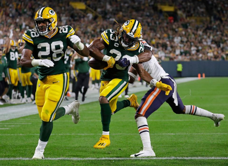 Packers running back AJ Dillon blocks for running back Aaron Jones as he scores a touchdown against the Chicago Bears on Sept. 18, 2022, at Lambeau Field in Green Bay, Wis.