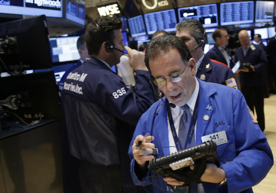 Traders work on the floor at the New York Stock Exchange in New York, Tuesday, Dec. 31, 2013. (AP Photo/Seth Wenig)