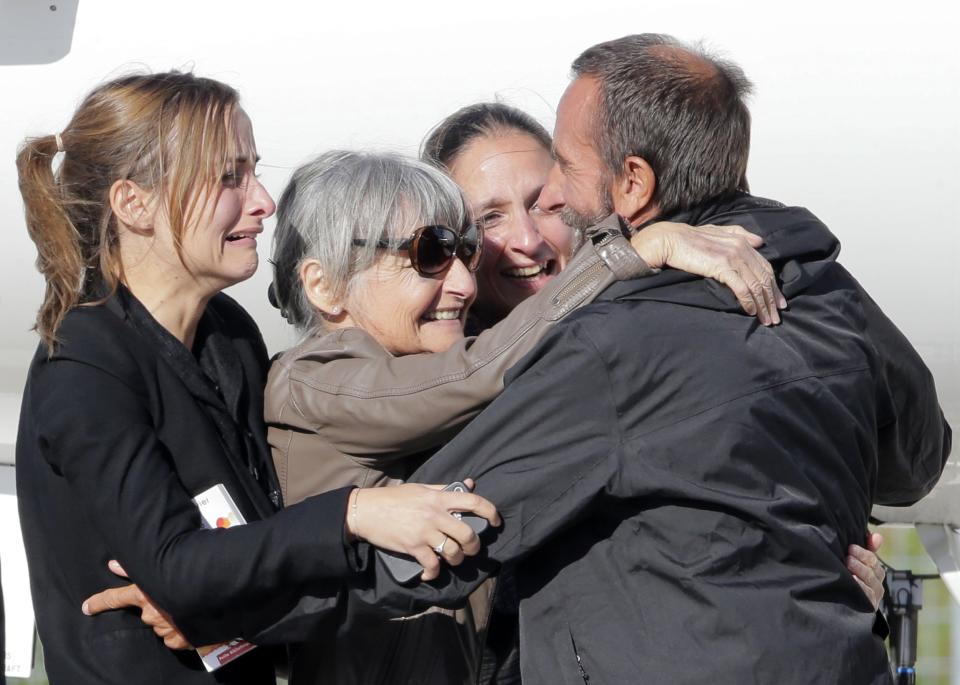 Freed French hostages arrive home