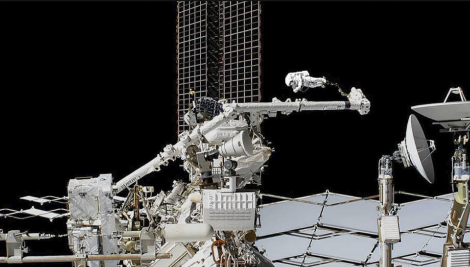 In this photo provided by NASA, astronaut Luca Parmitano is guided on the Canadarm2 robotic arm toward the work site on the Alpha Magnetic Spectrometer, the space station’s cosmic particle detector at the International Space Station, Friday, Nov. 22, 2019. Spacewalking astronauts ventured out for the second week in a row Friday to repair a cosmic ray detector, this time actually cutting into the $2 billion instrument. (NASA via AP)