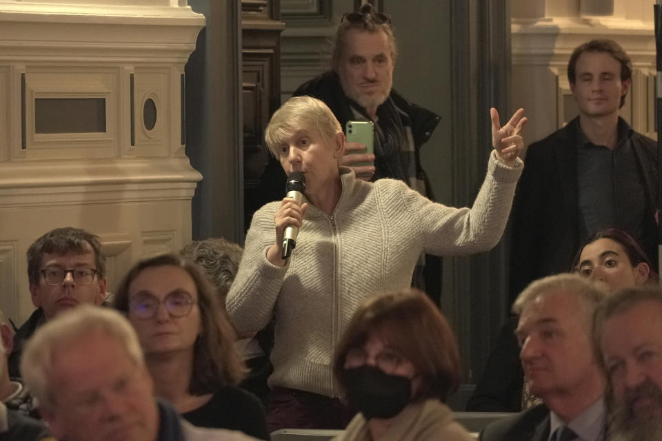 A Parisian asks a question during a meeting with Paris officials at a Paris townhall, Thursday, Feb.8, 2024. Officials spent more than two hours explaining the security, traffic and other arrangements that will be in place and took questions. Paris officials, Games organizers and government ministries are in the midst of concerted campaigns to explain to Parisians how the July 26-Aug.11 Summer Olympics and Paralympics that follow will impact their lives and how they can adapt. (AP Photo/John Leicester)