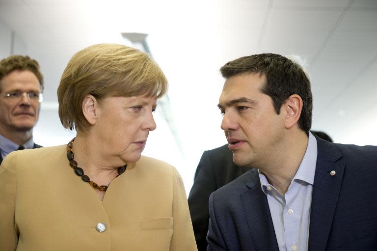 German chancellor Angela Merkel (L) talks with Greek Prime Minister Alexis Tsipras at the EU eastern Partnership Summit in Riga, on May 22, 2015