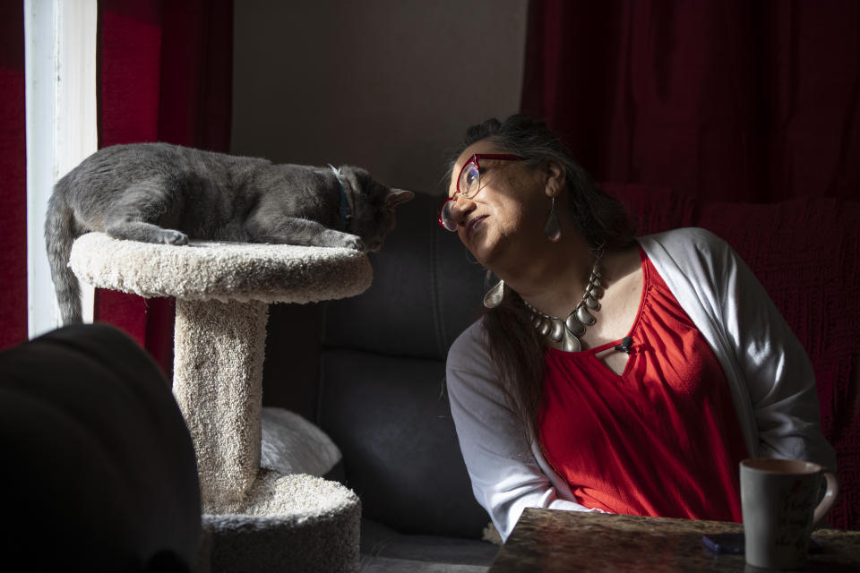 Christina Wood sits beside her cat, Miss Kitty, in her home in Salem, Ore., Friday, April 21, 2023. For most of her life in New Mexico, Wood felt like she had to hide her identity as a transgender woman. So six years ago she moved to Oregon, where she could access the gender-affirming health care she needed to live as her authentic self. (AP Photo/Amanda Loman)