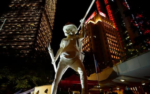 A statue of a protester titled "Lady Liberty Hong Kong" on display during a rally in Hong Kong on Friday - Credit: Vincent Yu/AP