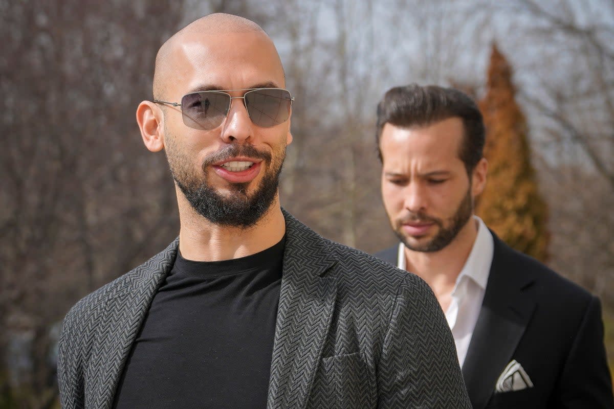 Andrew Tate, left, and his brother Tristan arrive at the Bucharest Tribunal in Romania (Vadim Ghirda/AP) (AP)