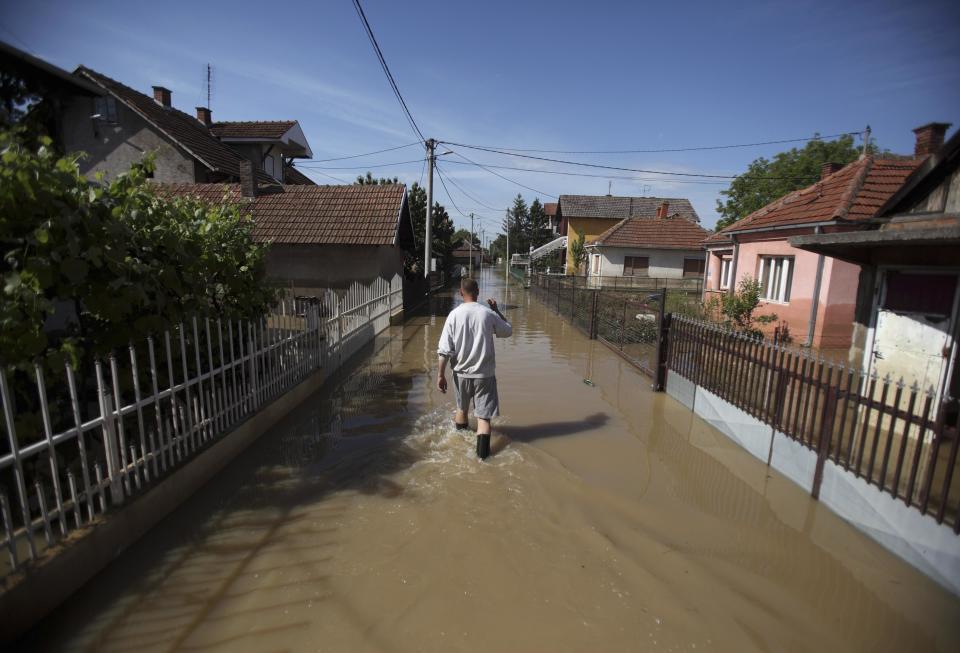 Man walks through flood waters in the town of Smedarevska Palanka