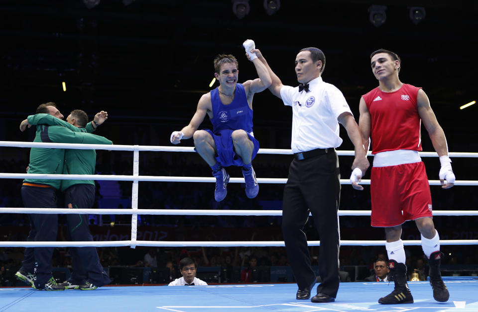 Ireland's Michael Conlan celebrates as he is declared the winner over France's Nordine Oubaali (R) after their Men's Fly (52kg) quarter-final boxing match at the London Olympic Games August 7, 2012. REUTERS/Murad Sezer (BRITAIN - Tags: SPORT BOXING OLYMPICS) 