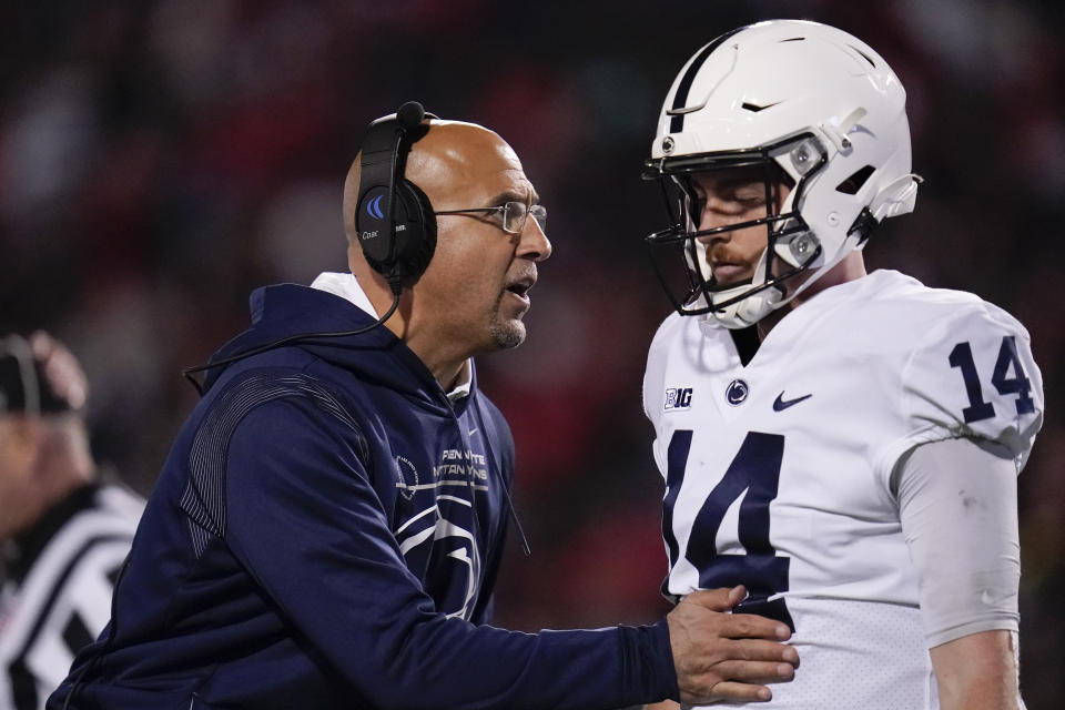 Penn State head coach James Franklin, left, talks with quarterback Sean Clifford during the second half of an NCAA college football game against Maryland, Saturday, Nov. 6, 2021, in College Park, Md. Penn State won 31-14. (AP Photo/Julio Cortez)
