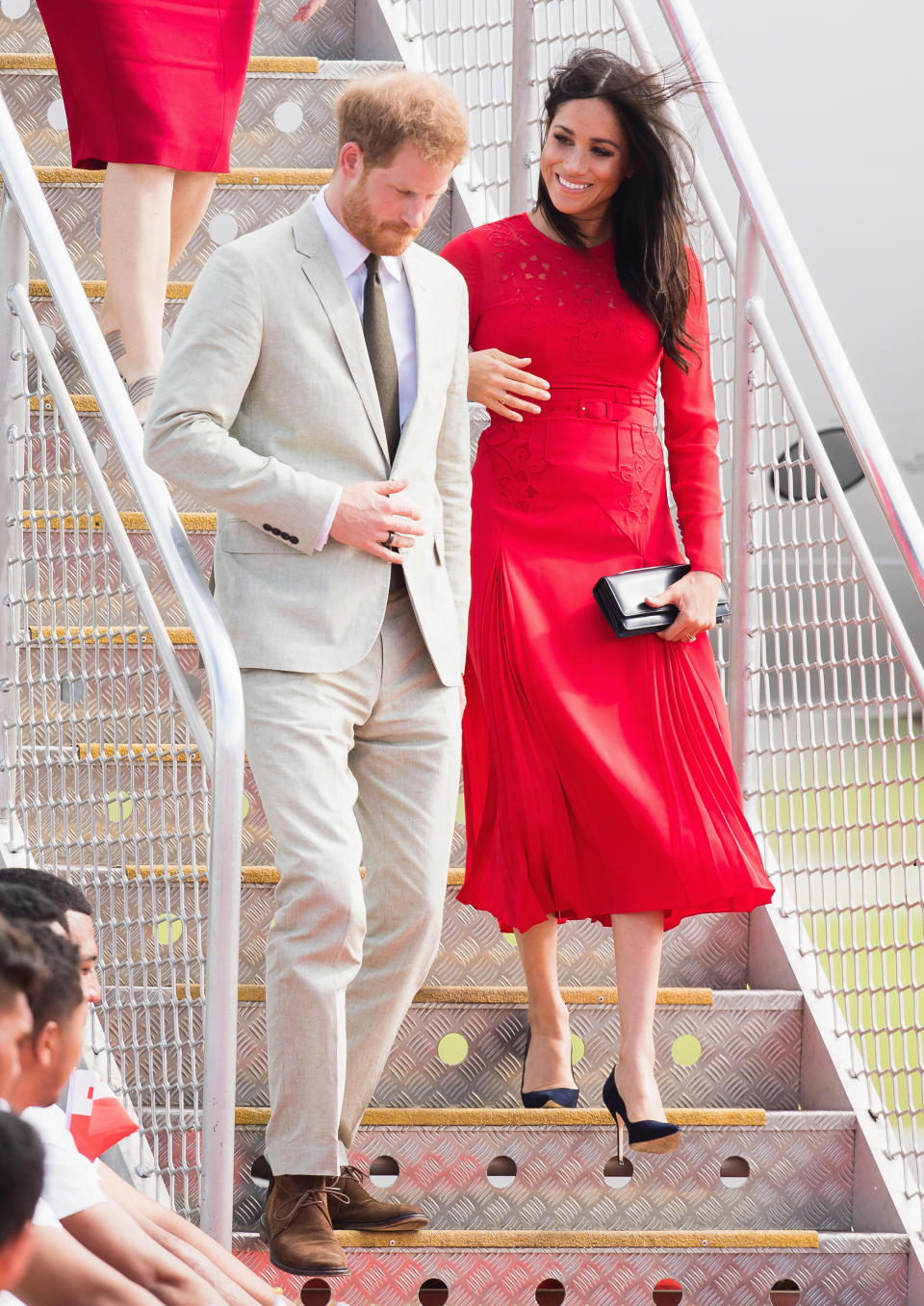 The Duchess stepped off the plane in a stunning red Self Portrait dress. Photo: Getty