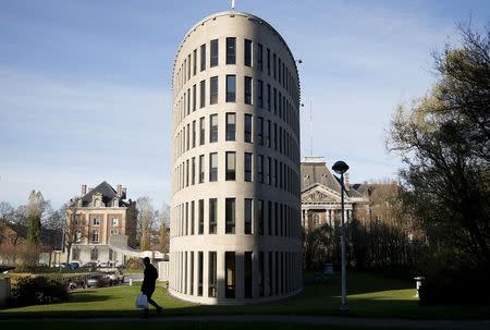 A pedestrian walks past a closed building of Flemish university VUB in Brussels, November 23, 2015, after security was tightened in Belgium following the fatal attacks in Paris. REUTERS/Francois Lenoir