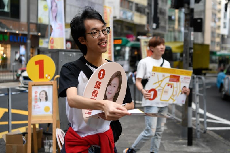 People campaign for Susi Law, a candidate in Sunday’s district council elections in Hong Kong