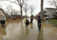 <p>Louisville residents are forced to use boats and kayaks to get to their homes along the Ohio River, after it flooded Louisville, Ky., Feb. 25, 2018. (Photo: John Sommers II/Reuters) </p>