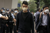 Pro-democracy activist Cheng Tat-hung, center, arrives at the West Kowloon Magistrates' Courts to attend his national security trial in Hong Kong, Monday, Feb. 6, 2023. Some of Hong Kong's best-known pro-democracy activists went on trial Monday in the biggest prosecution yet under a law imposed by China's ruling Communist Party to crush dissent. (AP Photo/Anthony Kwan)
