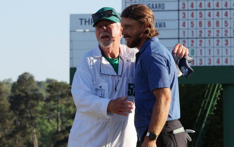 Tommy Fleetwood with his caddie on the 18th green