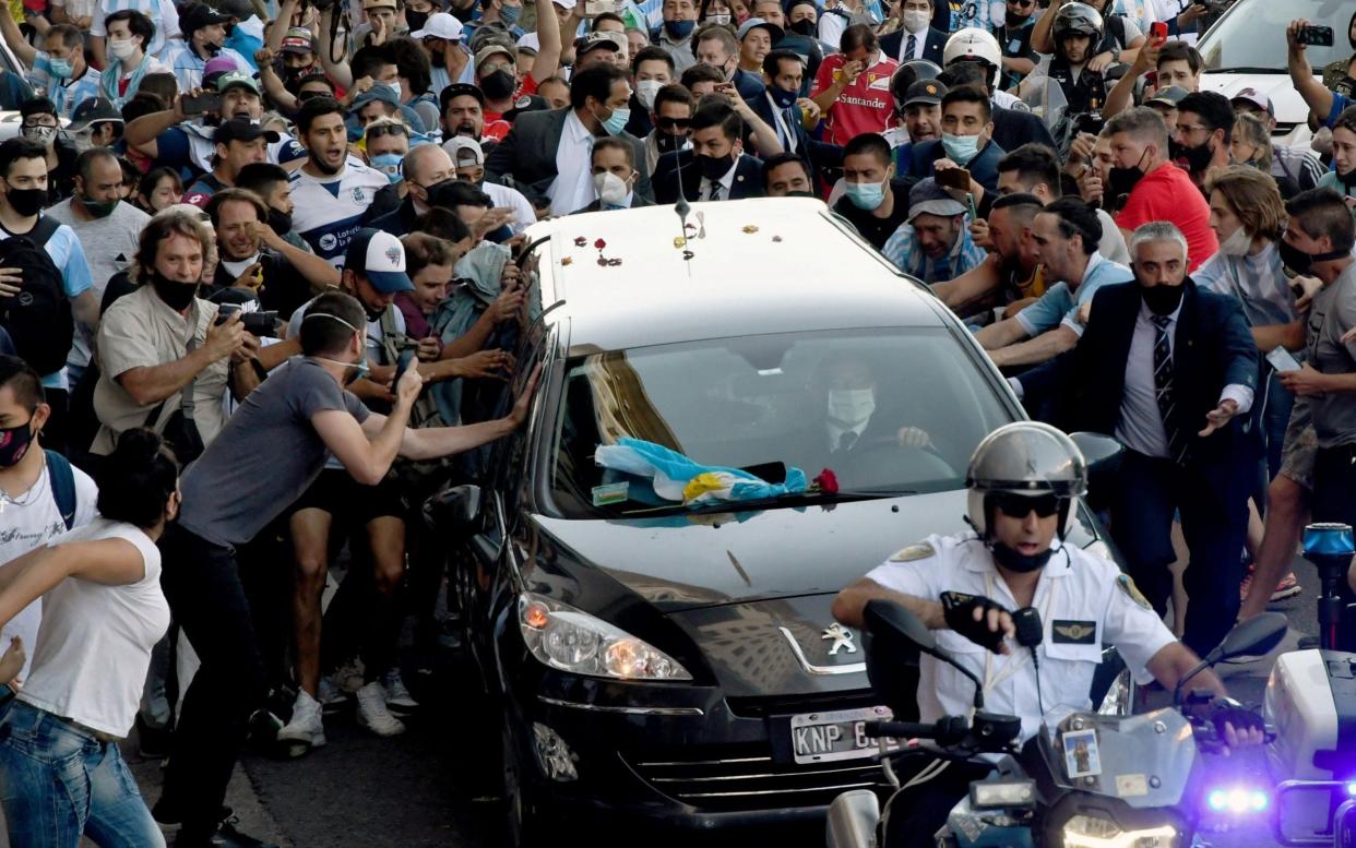 The hearse carrying the late Argentine football legend Diego Armando Maradona on its way from Casa Rosada presidential palace to the cemetery - AFP