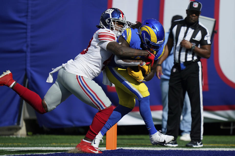 Los Angeles Rams' Darrell Henderson, right, scores a touchdown while New York Giants' Tae Crowder tries to stop him during the first half of an NFL football game, Sunday, Oct. 17, 2021, in East Rutherford, N.J. (AP Photo/Frank Franklin II)