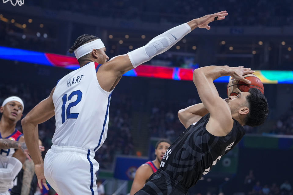 New Zealand guard Shea Ili (5) shoots over U.S. forward Josh Hart (12) during the first half of a Basketball World Cup group C match in Manila, Saturday, Aug. 26, 2023. (AP Photo/Michael Conroy)