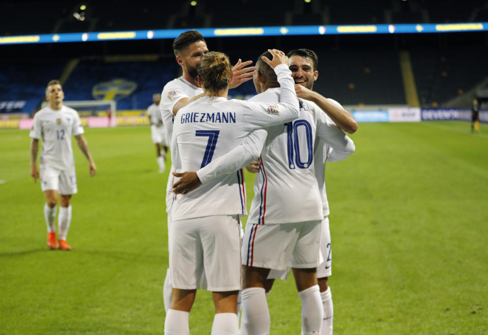 France's Kylian Mbappe, 10, is congratulated by his teammates after scoring a goal during the UEFA Nations League soccer match between Sweden and France at Friends Arena, Saturday, Sept. 5, 2020, in Stockholm, Sweden. (Christine Olsson/TT via AP)