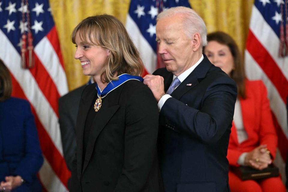 <p>ANDREW CABALLERO-REYNOLDS/AFP via Getty</p> US President Joe Biden presents the Presidential Medal of Freedom to US swimmer Katie Ledecky (L) in the East Room of the White House